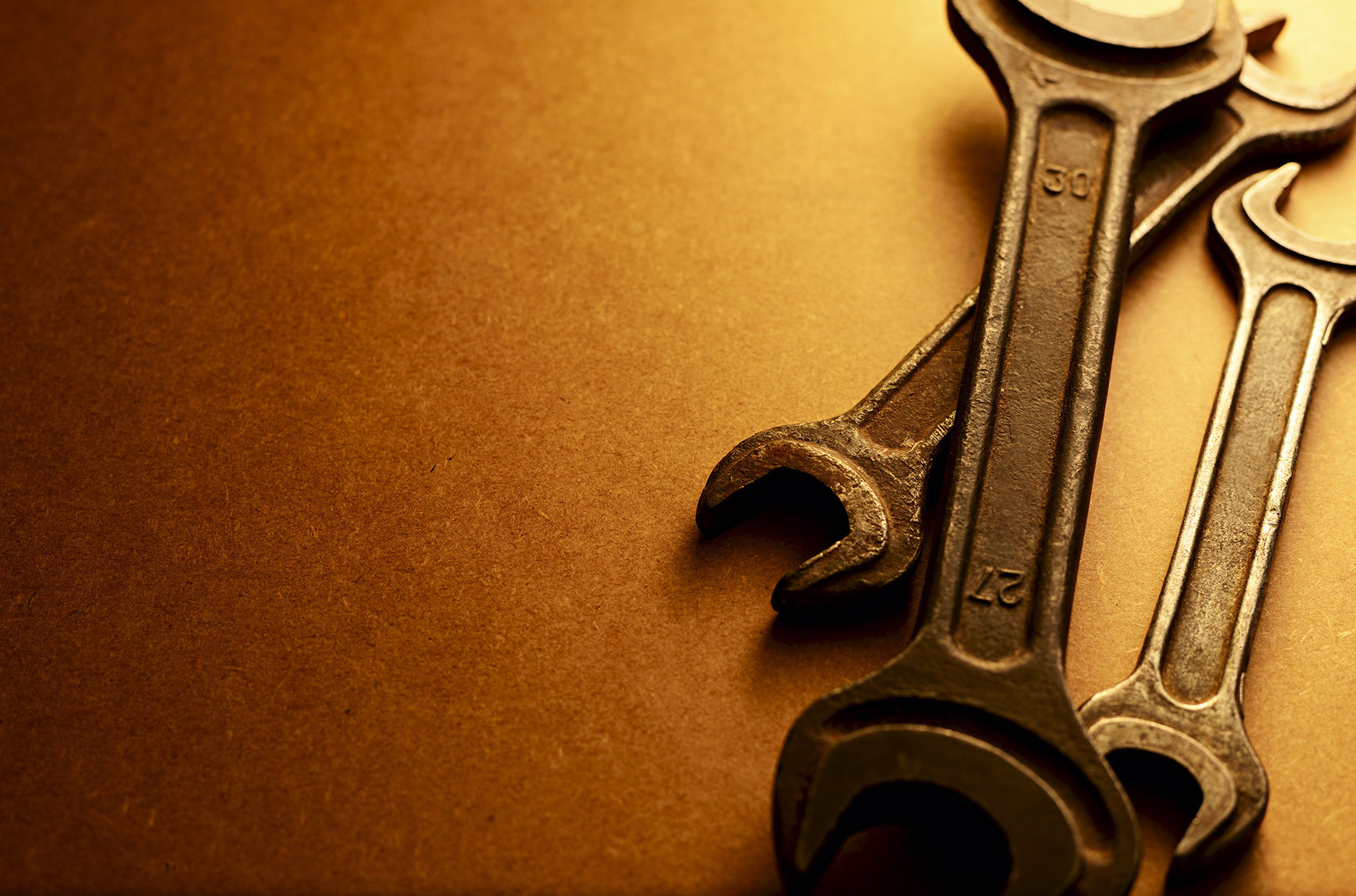 Wrenches on brown background